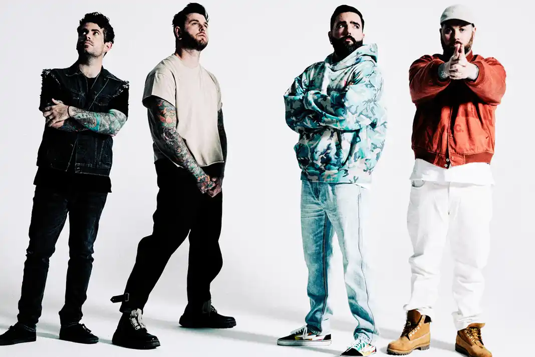 Four individuals posing in casual attire.