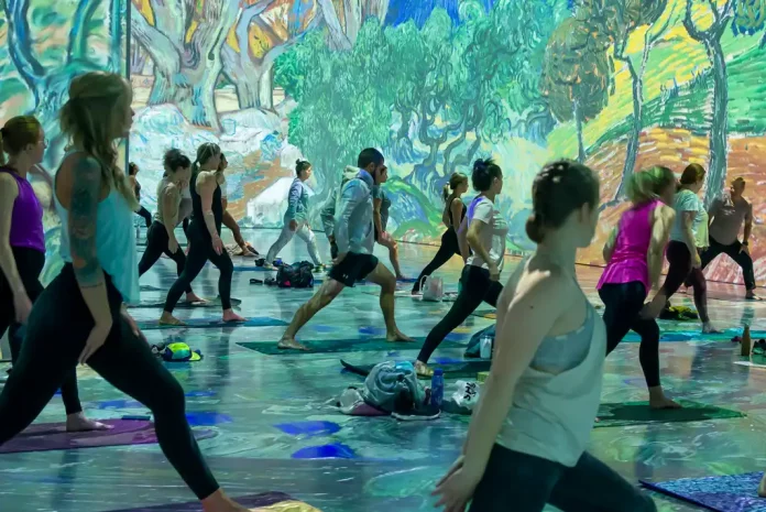 Group yoga session with vibrant backdrop.