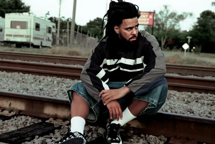 J,.Cole sitting on train tracks.