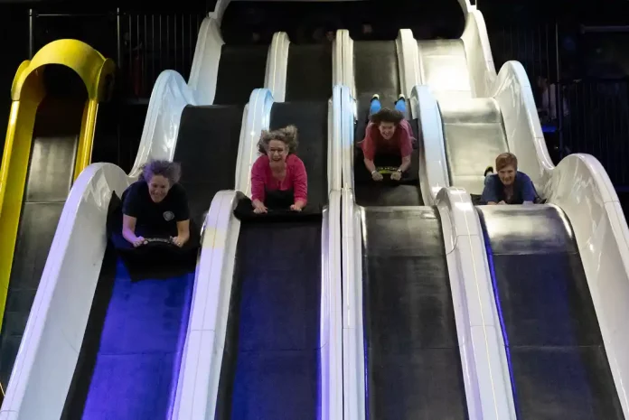 slickcitymain People sliding down indoor slides at Slick City