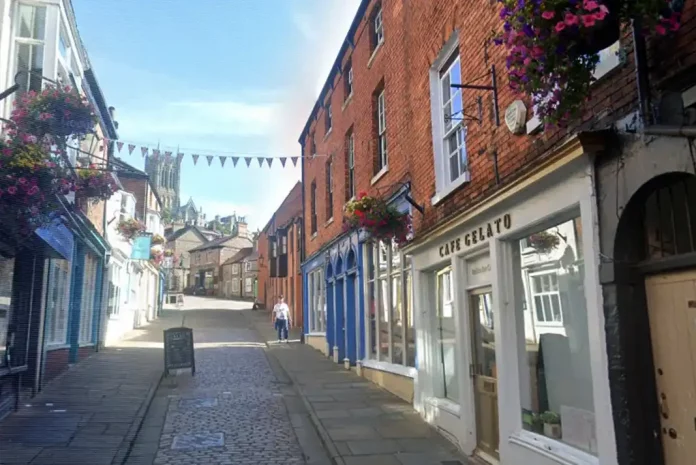Charming street with shops and flowers.