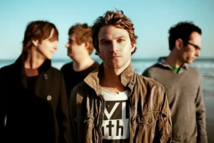 American Hi-Fi posing on beach at sunset