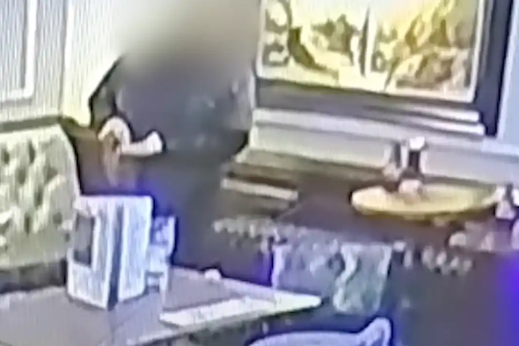 Blurred figure in a restaurant setting.