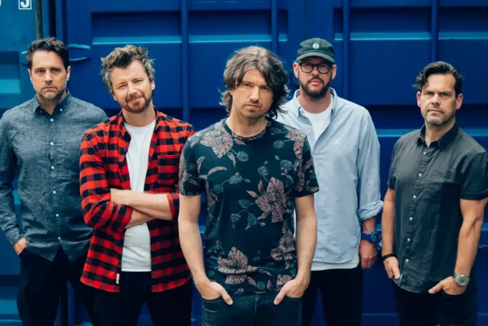 Five men posing in casual attire.