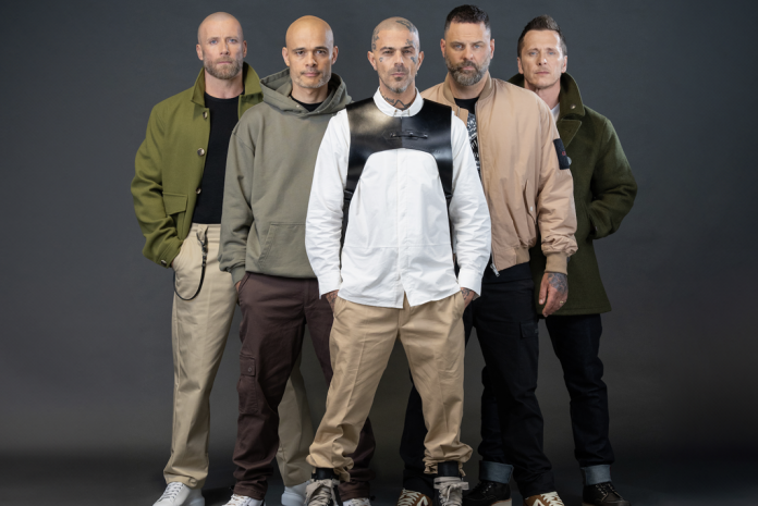 Group of five people posing together