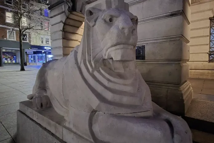 Stone lion statue at night