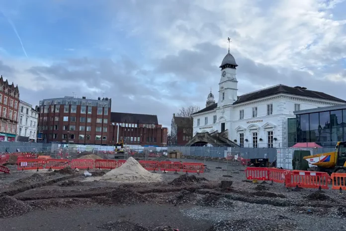 Construction site with surrounding buildings.