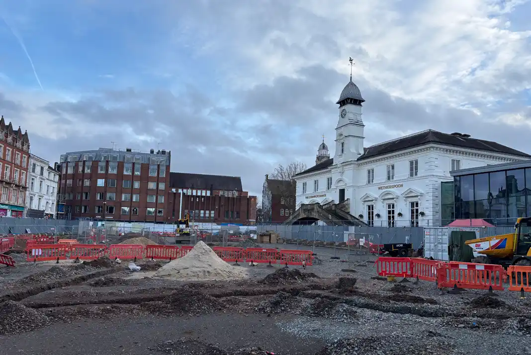 Construction site with surrounding buildings.