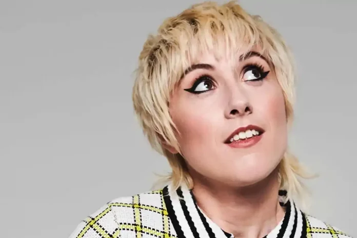 Person with short, styled blonde hair.