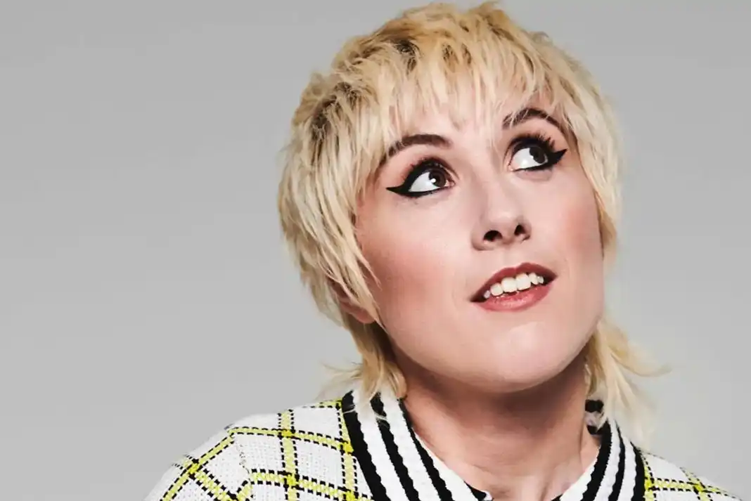 Person with short, styled blonde hair.