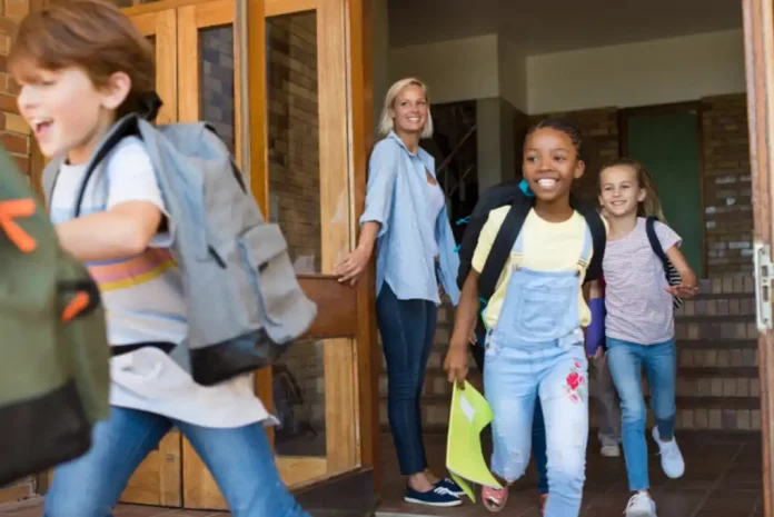 Children joyfully leaving school building