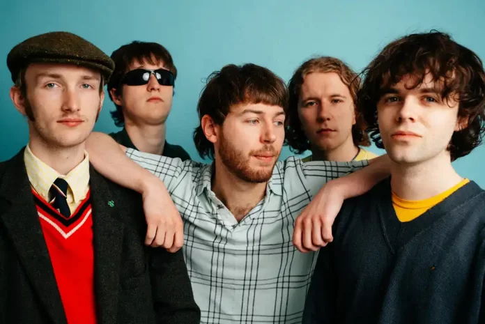 Five men in Brogeal posing against blue background