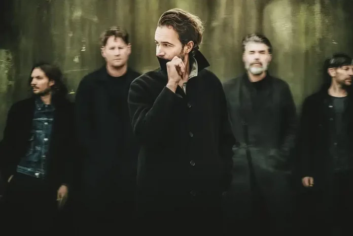 Band posing against a textured background