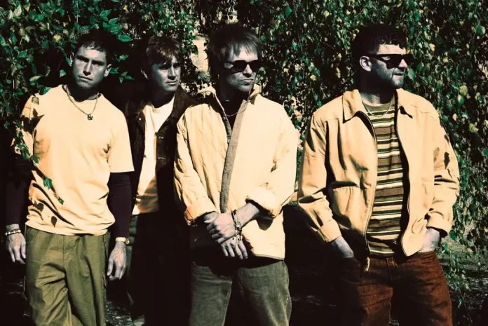 Enter Shikari band members in casual attire outdoors.