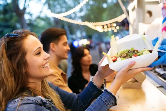 Young woman enjoying food at market