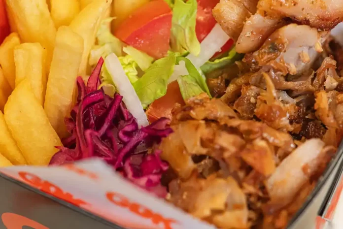 Döner kebab with fries and salad