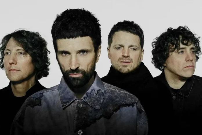 Four men with varying hairstyles posing