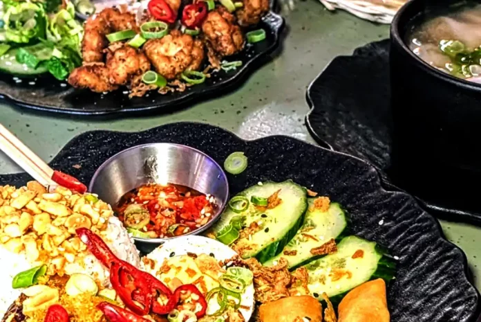 Colorful Asian cuisine on black plates