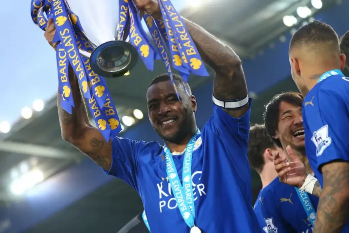 Leicester City captain Wes Morgan celebrating championship victory with trophy