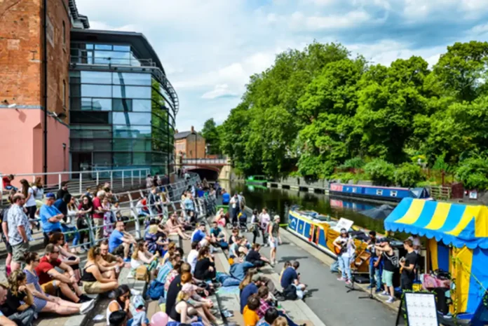 Crowd enjoying music by the canal.