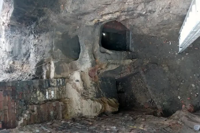 Dark, rocky underground cave structure.