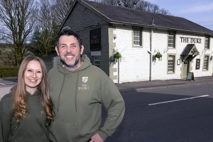Couple outside pub named The Duke